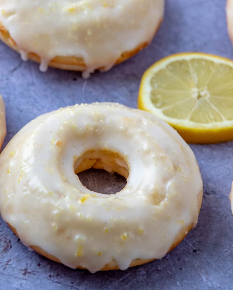 Close up of baked donut next to a lemon slice