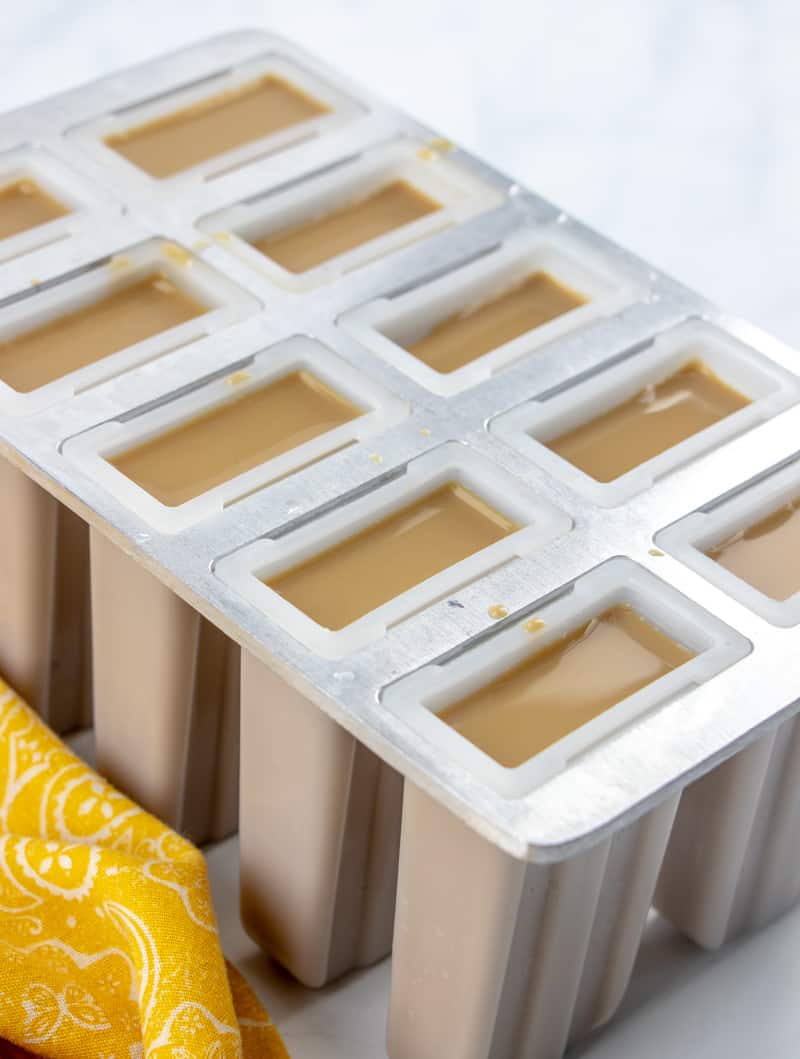 coffee and creamer mixture poured into popsicle molds