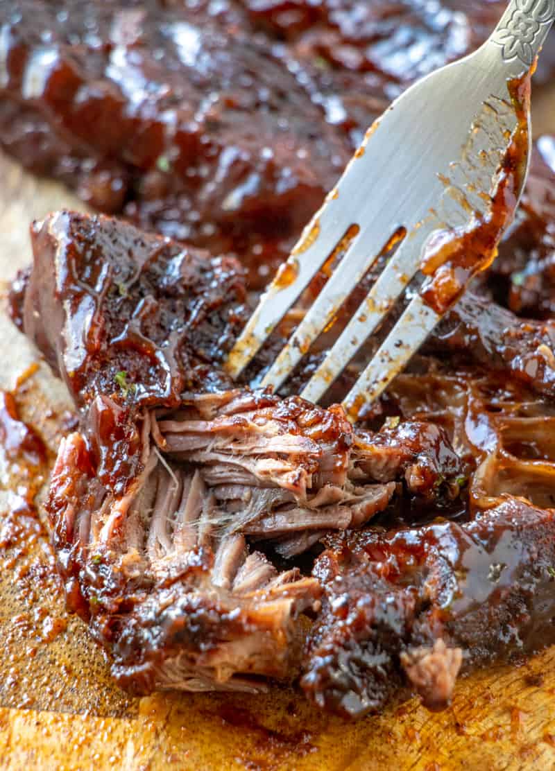 fork in rib shredding it showing juicy tender meat