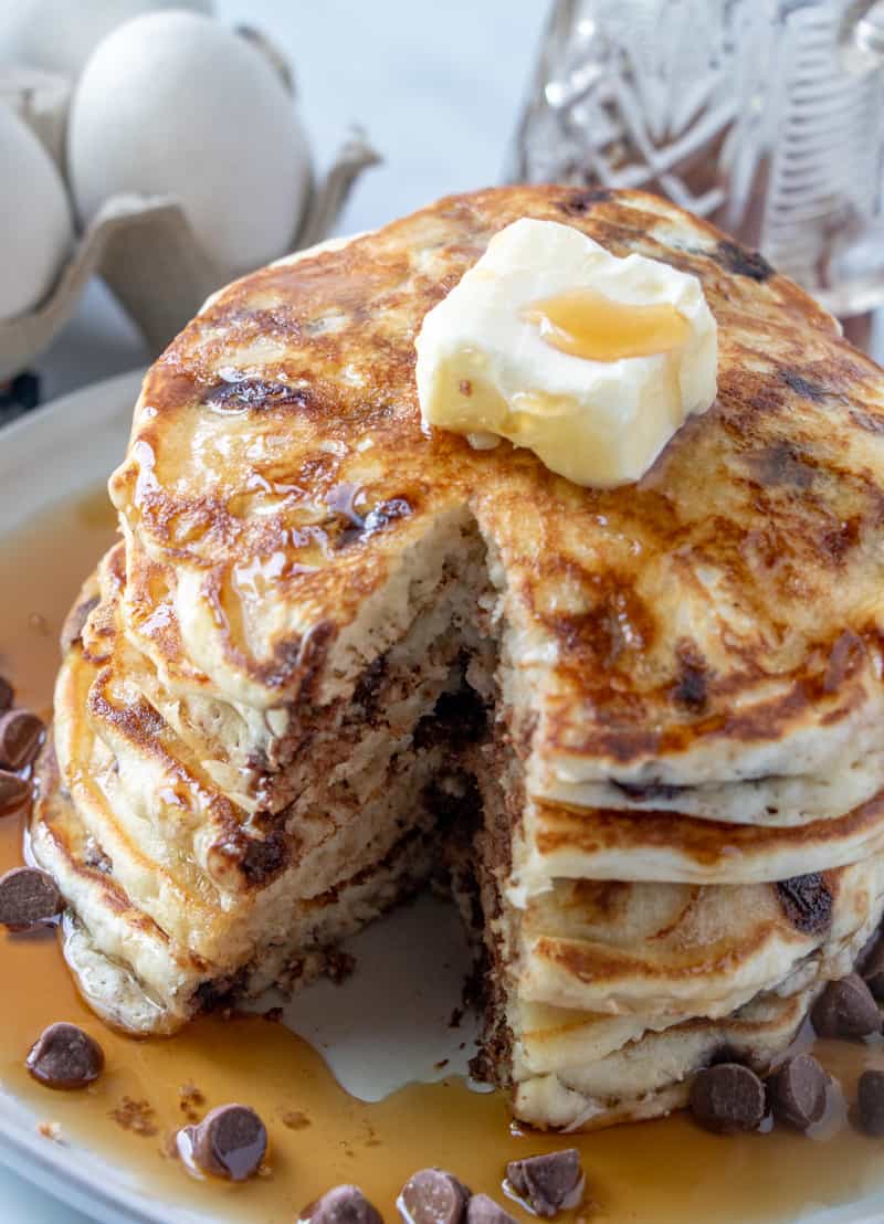 Chocolate chip pancakes with slices out of stacks showing inside of pancakes