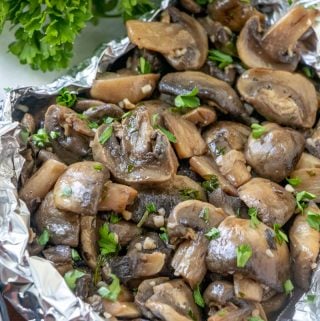 Finished Grilled Mushrooms with foil pack open sprinkled with chopped parsley