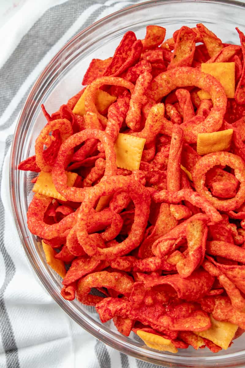 Flamin' Hot Party Mix in bowl above shot showing all different snacks