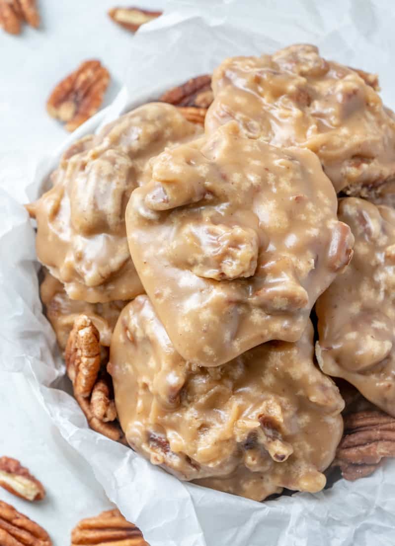 Overhead photo of pralines in bowl with pecans lying around the edges 