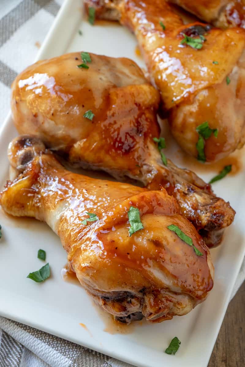 Close up photo of baked chicken drumstick on plate