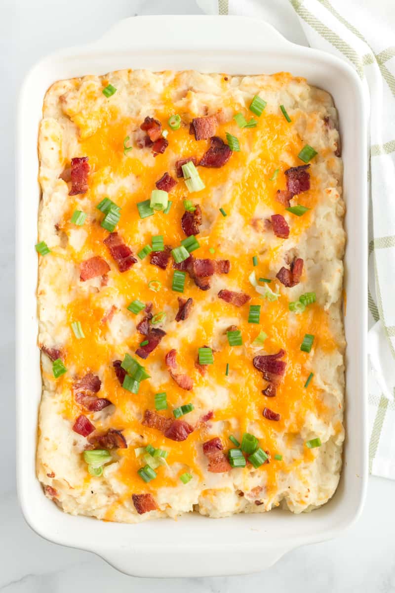 Mashed Potato Casserole right out of oven with melted cheese, bacon and green onions