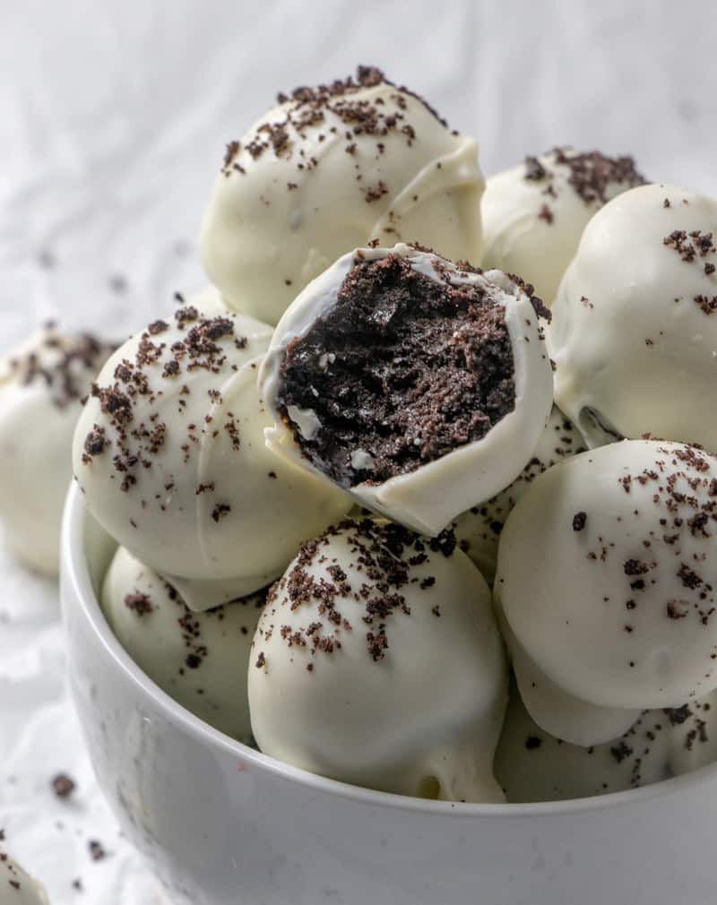 Inside on oreo truffle on top of stack of truffles in bowl