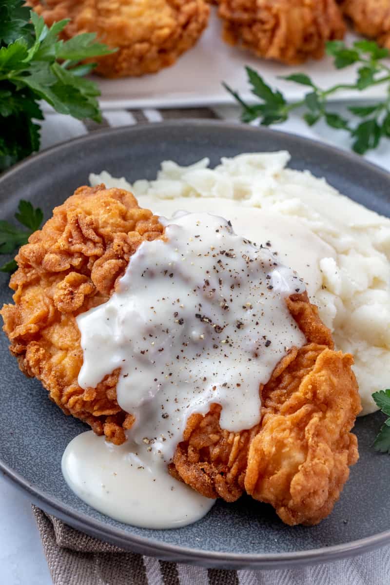 Chicken Fried Chicken over mashed potatoes with gravy and fresh cracked black pepper