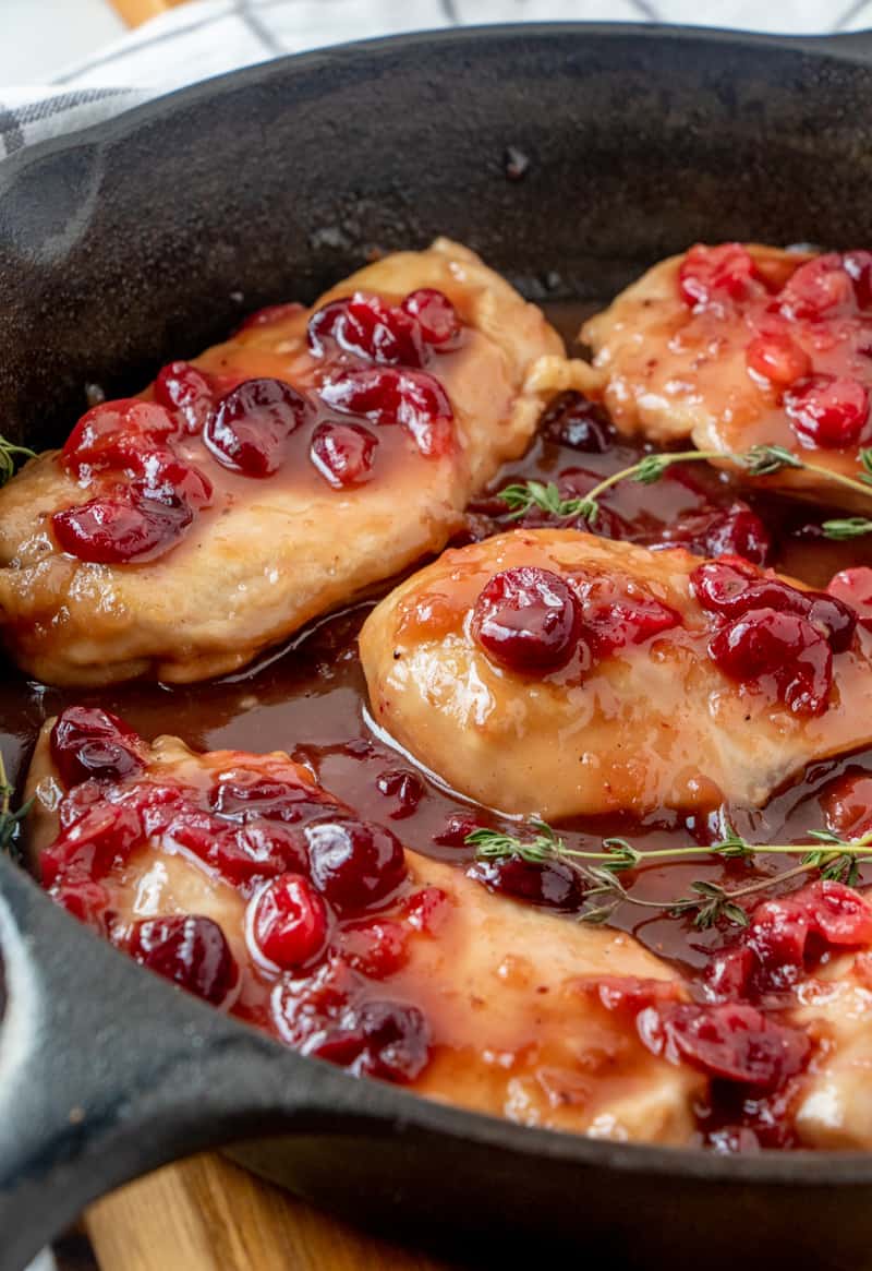 Close up photo of chicken glazed with cranberry sauce