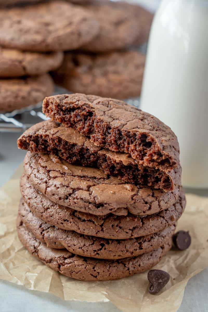 Cookies stacked on top of one another with one broken open showing the soft moist inside