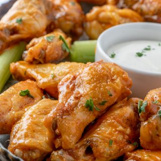 side view of wings on serving tray with ranch in back