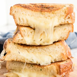 Grilled cheese sandwich cut in half and stacked on top of each other