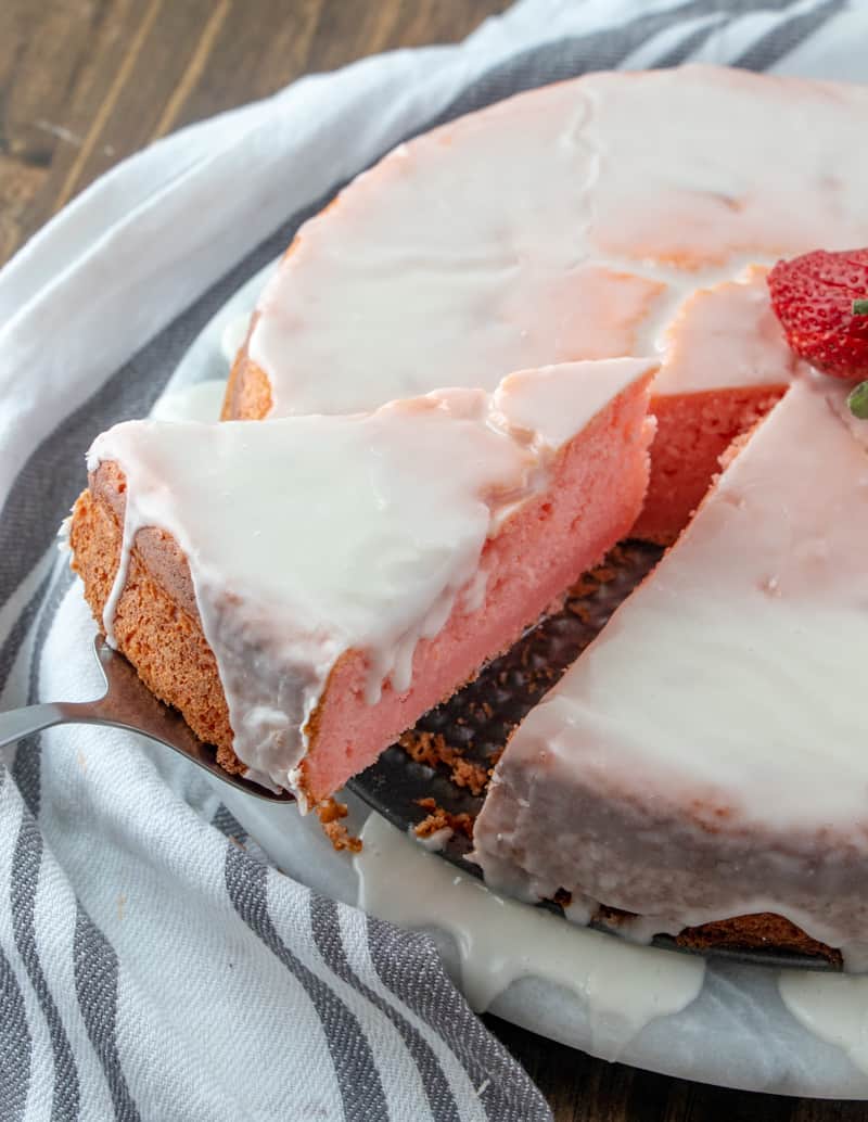 Slice of cake on cake server being removed from whole cake