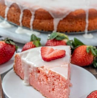 glazed ricotta cake on plate topped with a slice of strawberry