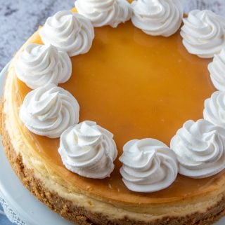 overhead of baked cheesecake topped with lemon curd and whipped topping