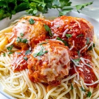 Three meatballs on top of spaghetti