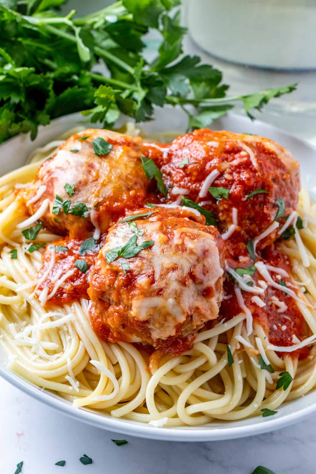 Three meatballs on top of spaghetti 