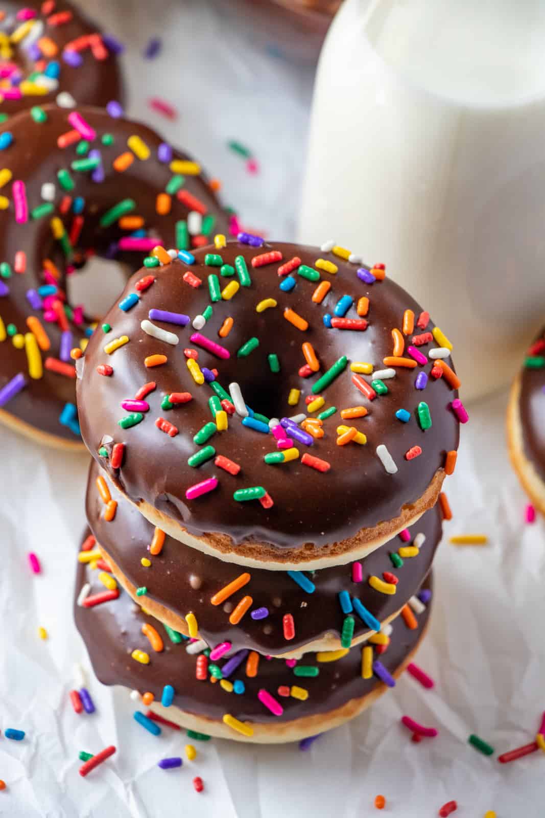 Overhead photo of stacked glazed donuts showing sprinkles