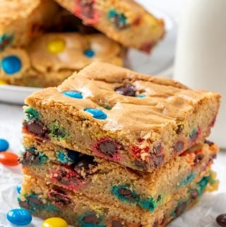 Three stacked M&M Blondies on parchment paper