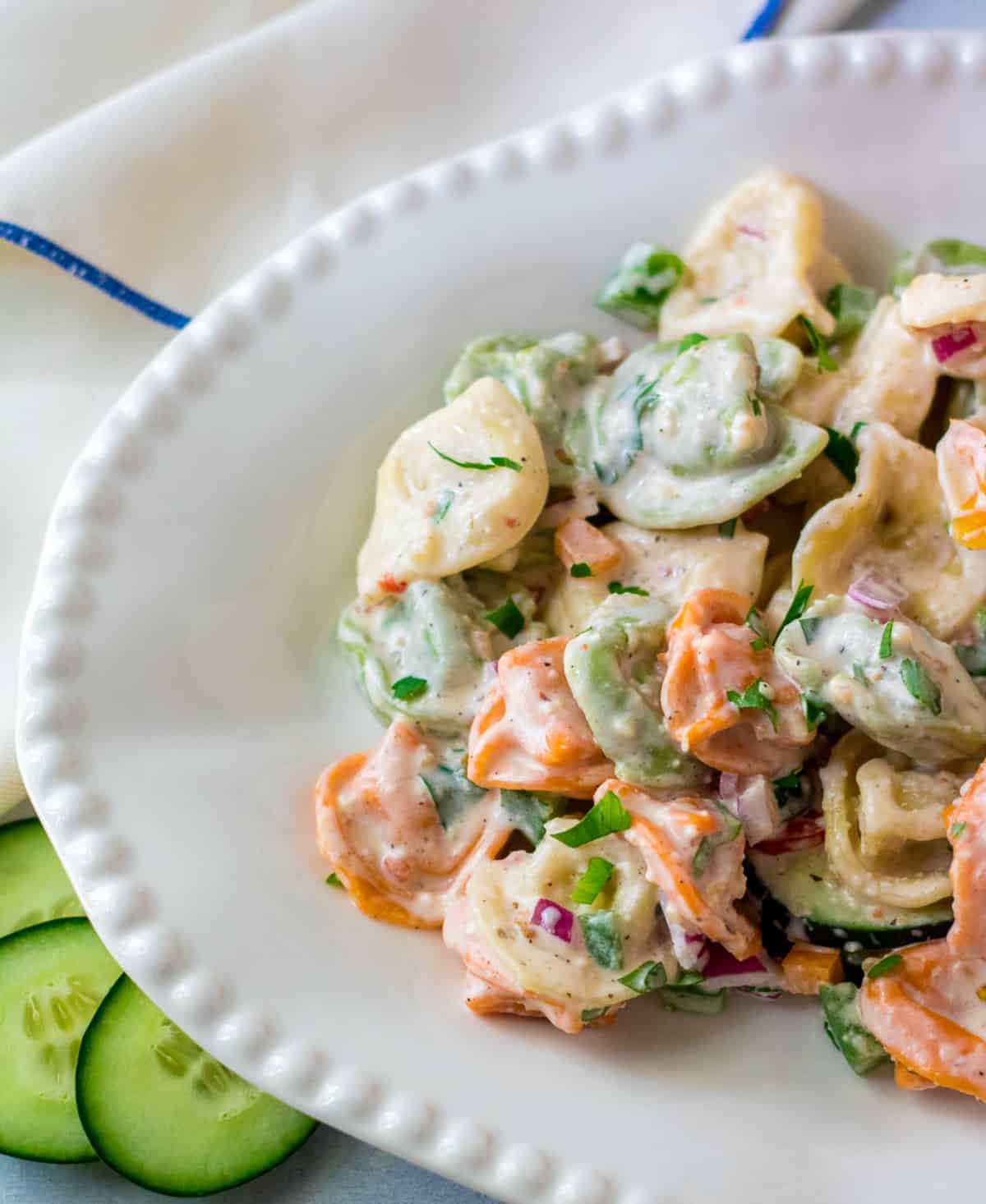 Close up of tortellini in bowl topped with parsley