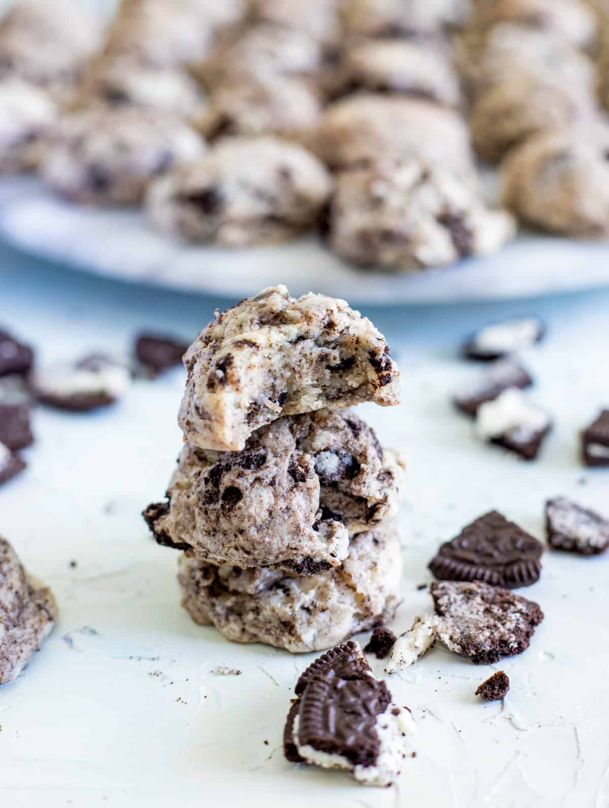 Three stacked cookies with crushed Oreos in front