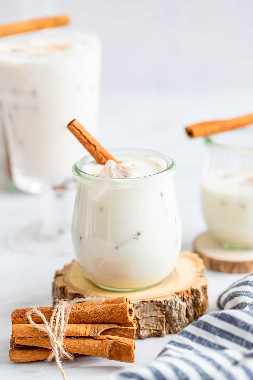 Three glasses of Horchata with cinnamon sticks