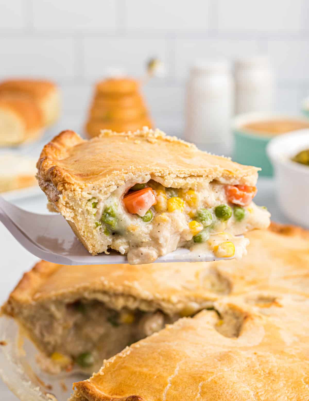 Pie server taking slice of Chicken Pot Pie out of pie plate