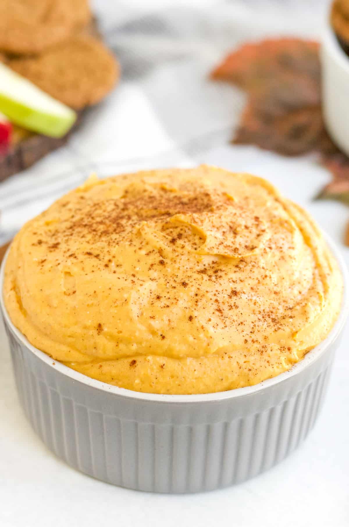 Pumpkin Dip in gray serving bowl topped with more pumpkin pie spice.
