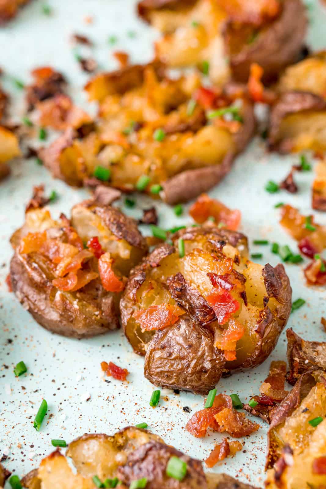 Close up of topped Smashed Potatoes stacked