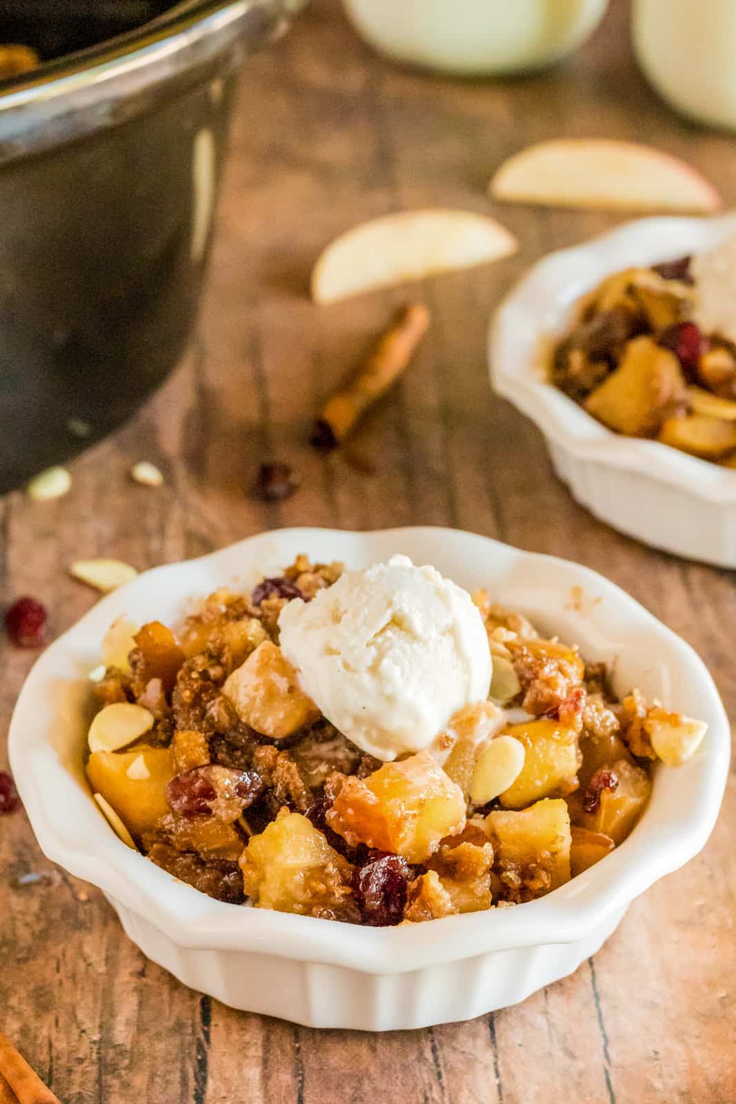 Bowl of Easy Apple Crumble next to crockpot