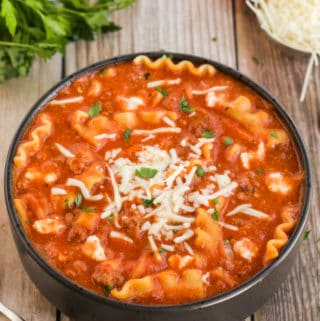 Lasagna Soup in black bowl with cheese