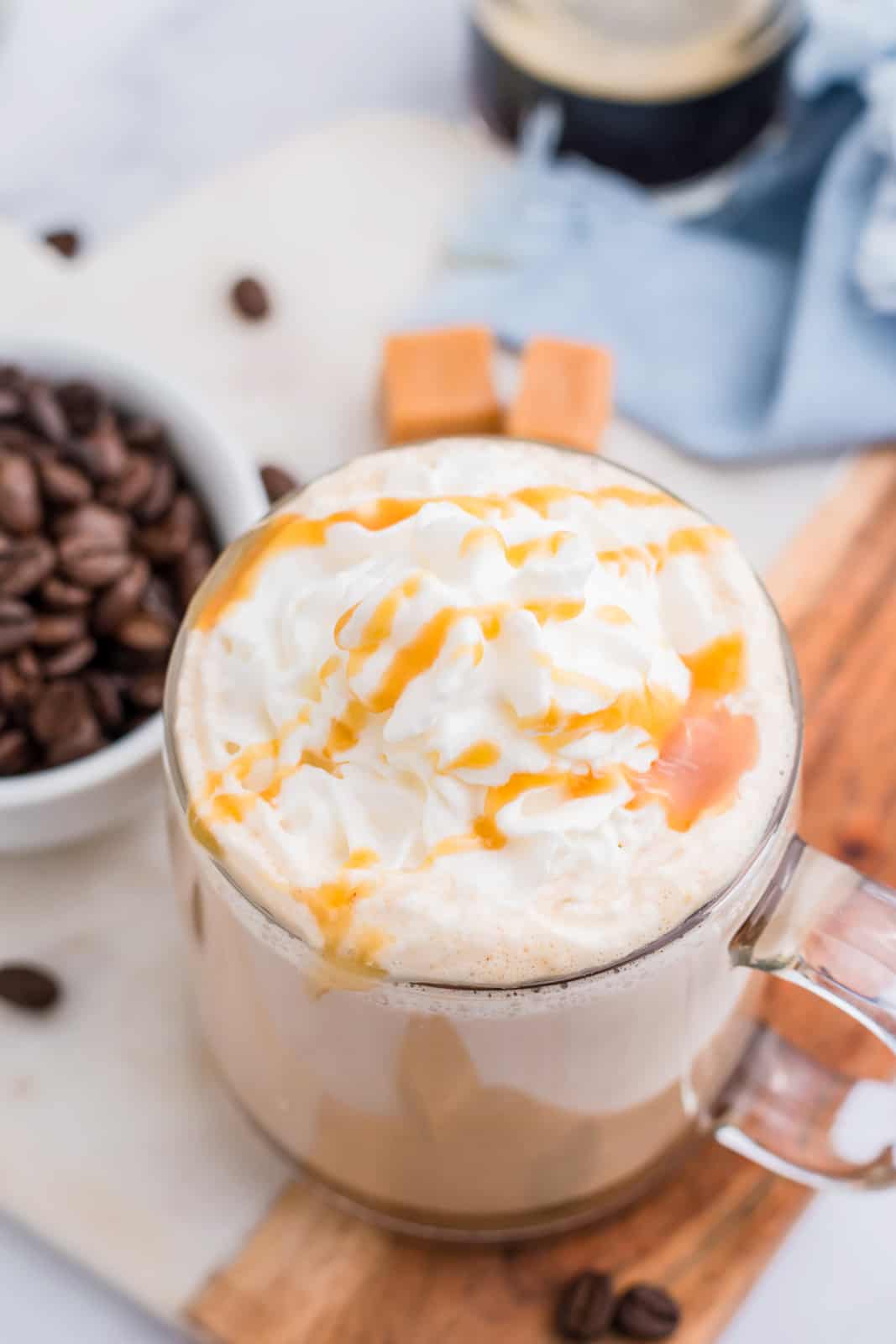 Overhead of Latte with whipped topping and caramel drizzle