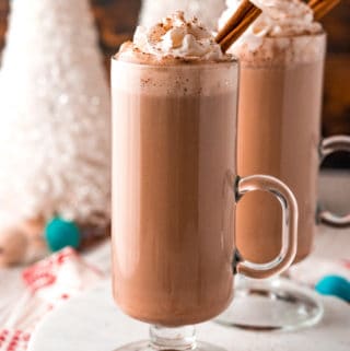 Two glasses of Eggnog Hot Chocolate on white platter