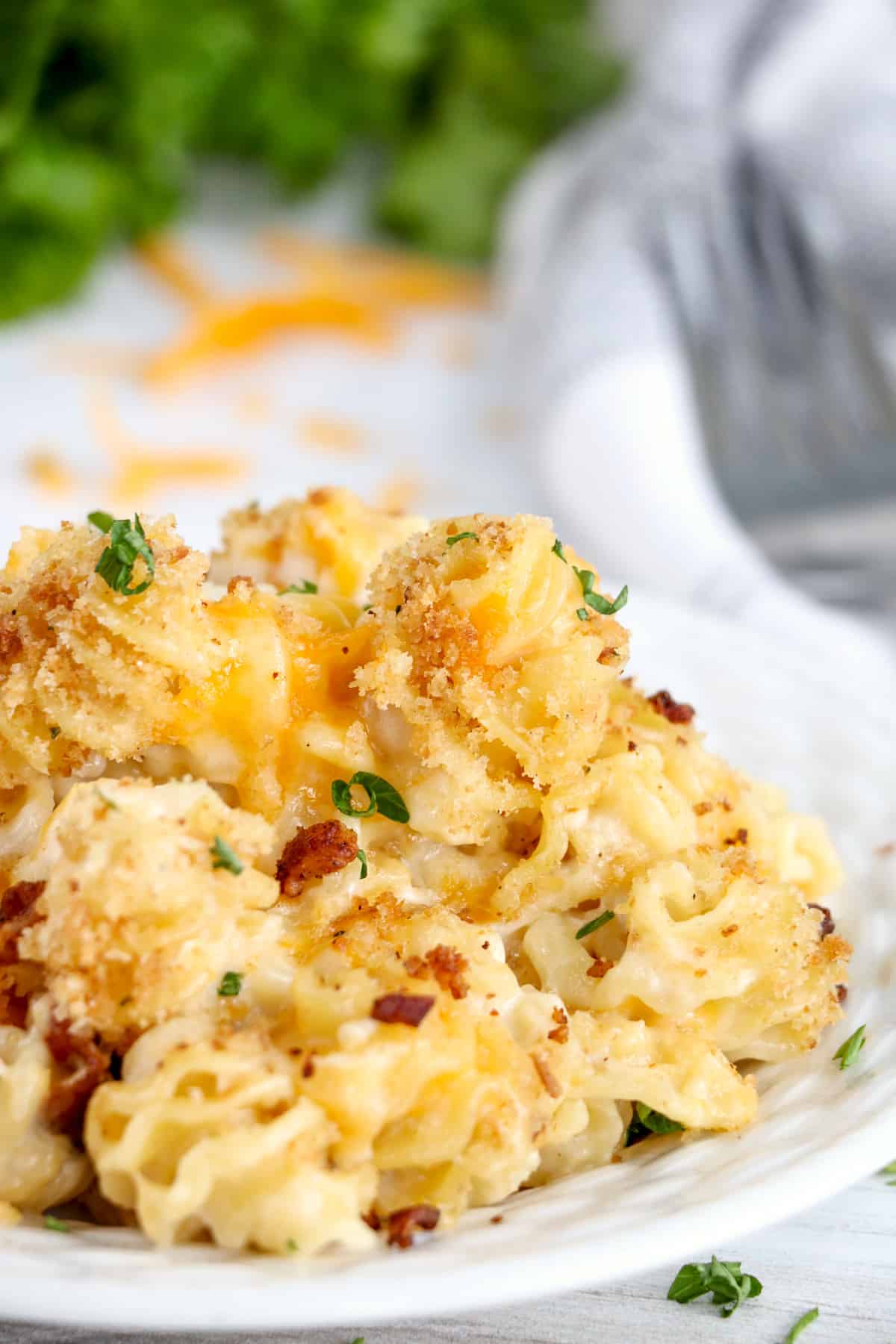 Pepper Jack Bacon Mac and Cheese on white plate topped with chopped parsley.