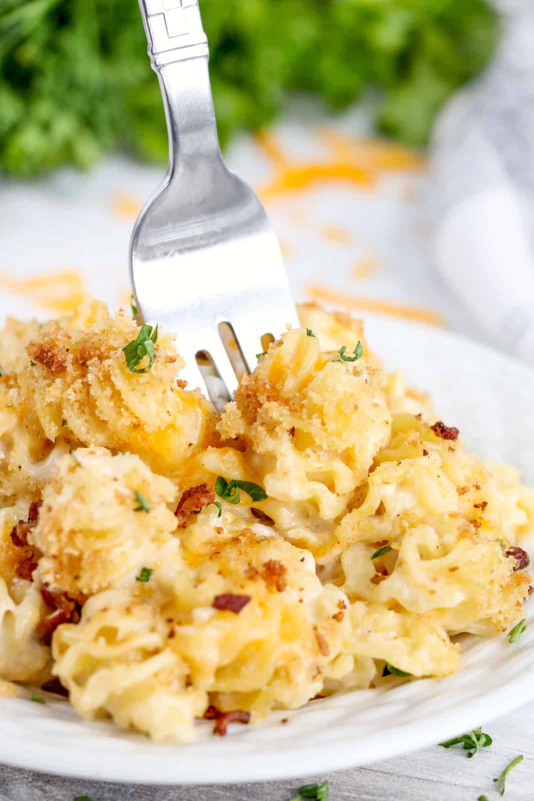 Fork poking into plate of Bacon Mac and Cheese