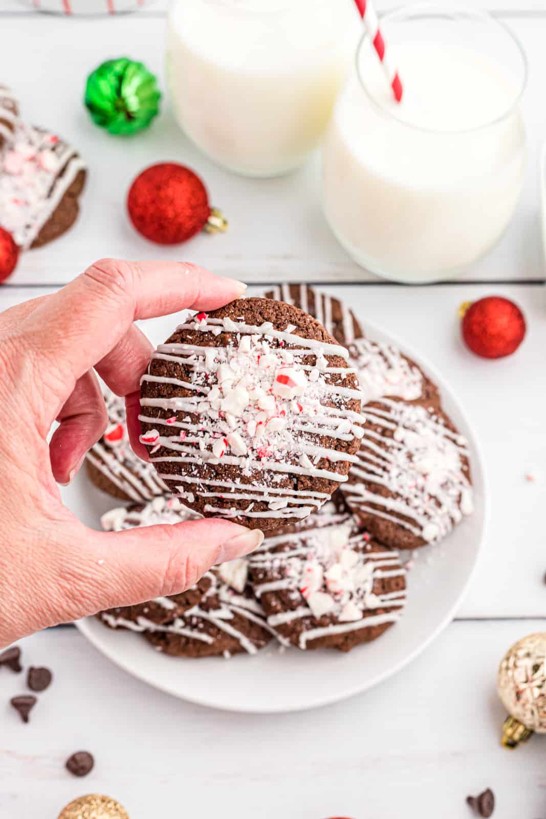 Hand holding one Peppermint Double Chocolate Cookie