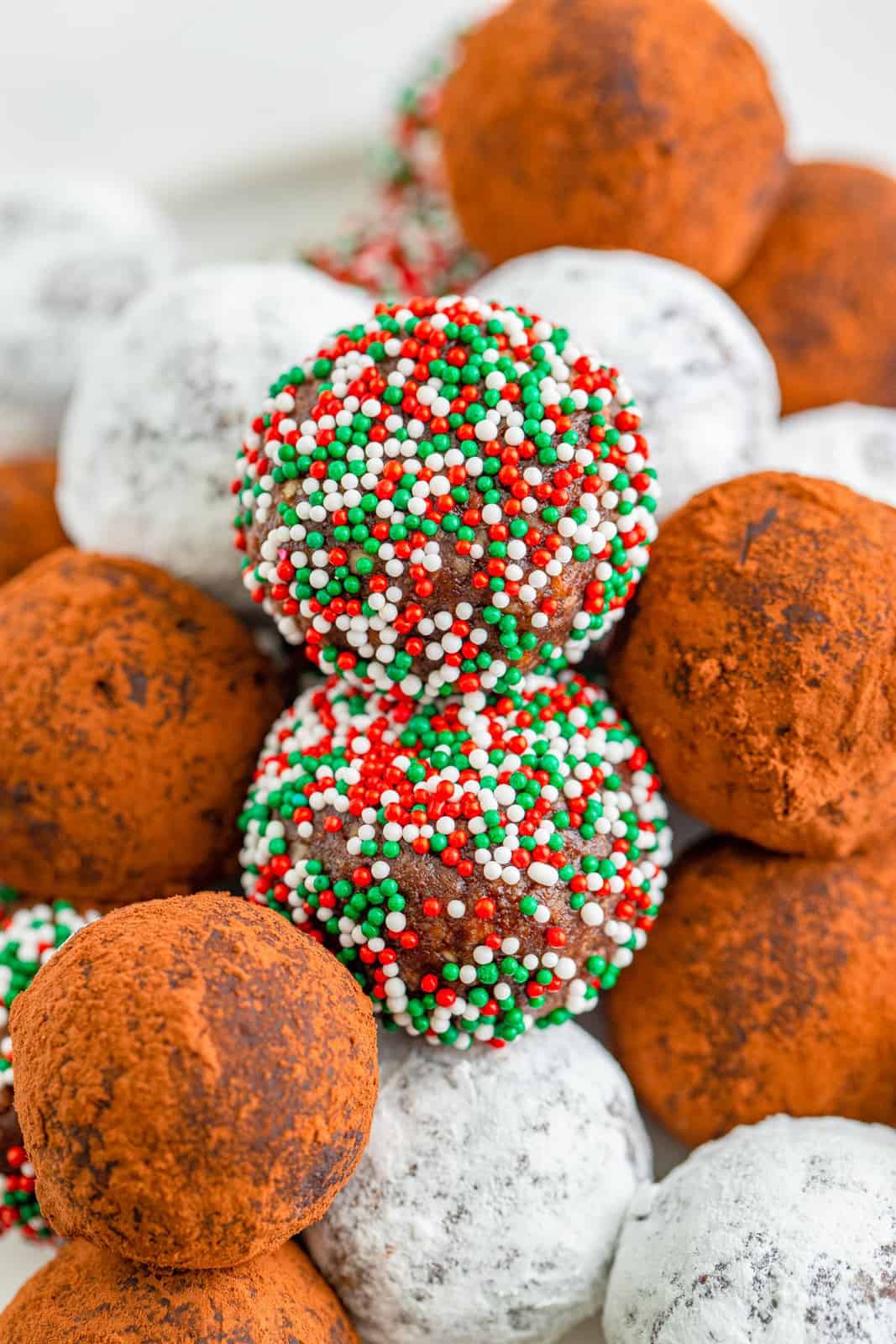 Close up of stacked balls showing sprinkles, cocoa powder and powdered sugar