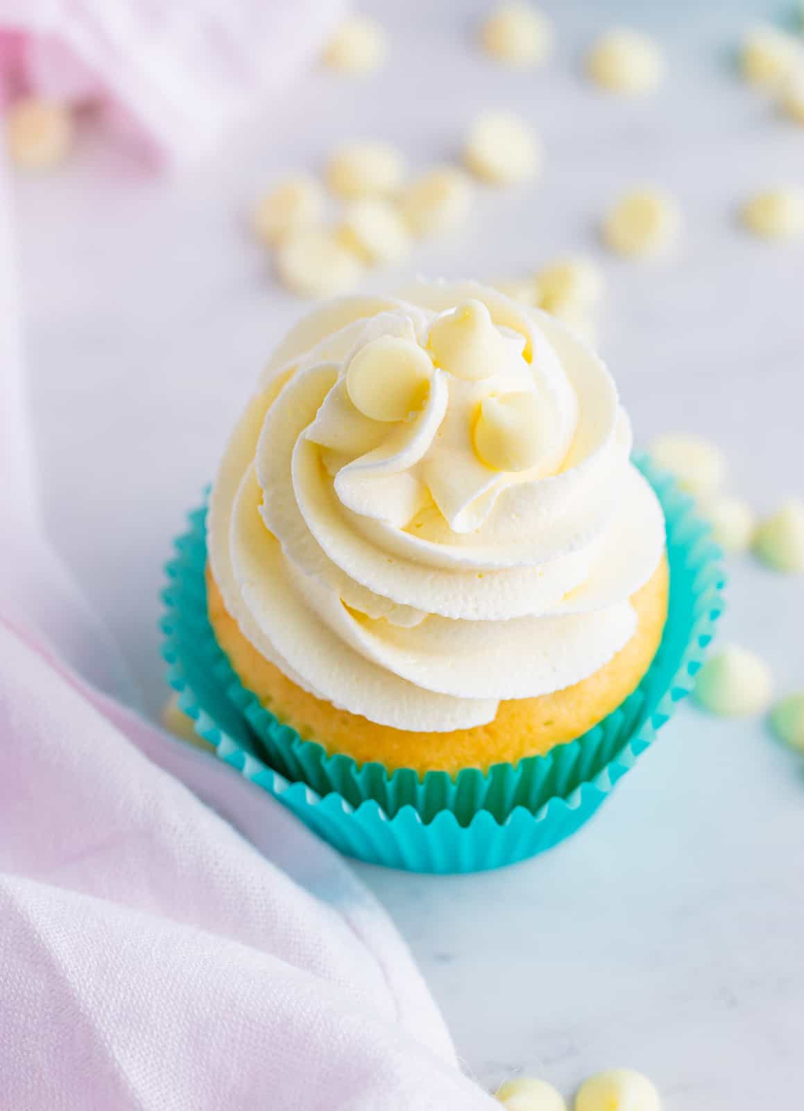 Overhead of one cupcake topped with buttercream