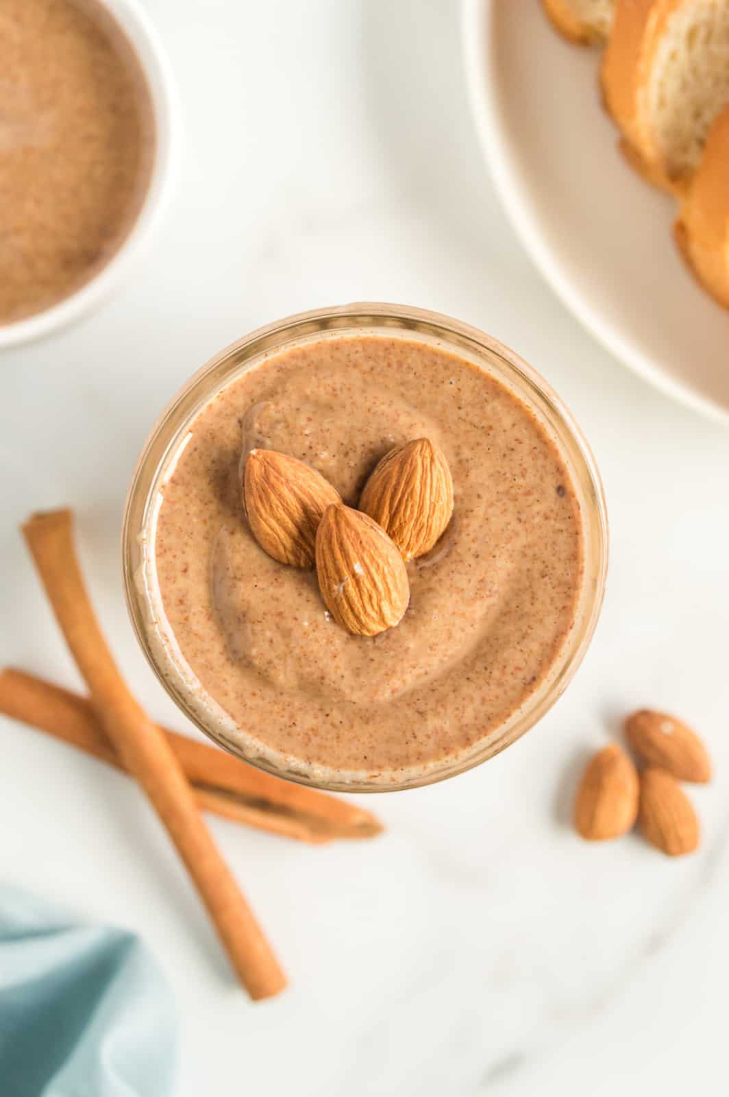 Overhead of Almond Butter in jar topped with almonds