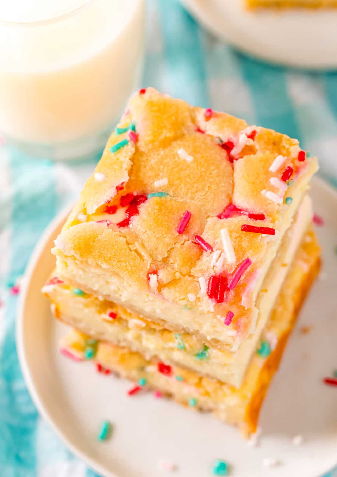 Overhead photo of stacked Funfetti Sugar Cookie Cheesecake Bars stacked