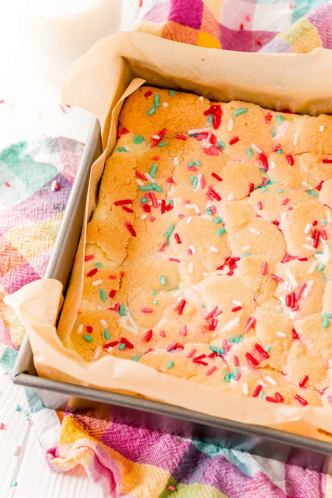 Overhead Photo of finished Funfetti Sugar Cookie Cheesecake Bars in pan, uncut