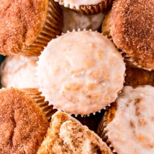 Close up square image of finished muffins glazed or topped with cinnamon sugar.