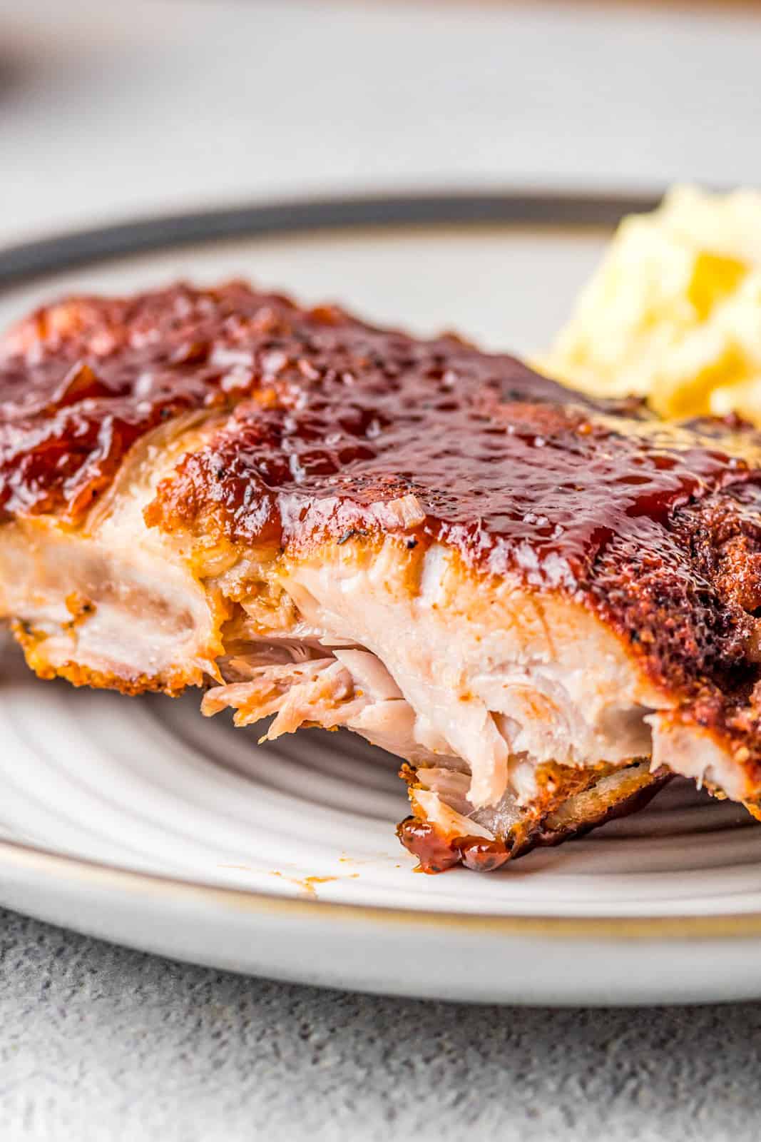 Close up of slice of Instant Pot BBQ Ribs on plate