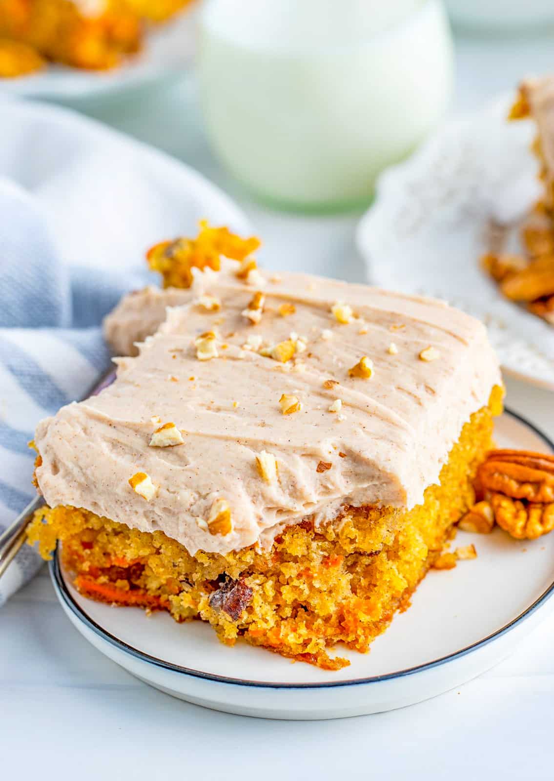 Close up of a slice of The Best Carrot Cake with bite taken out