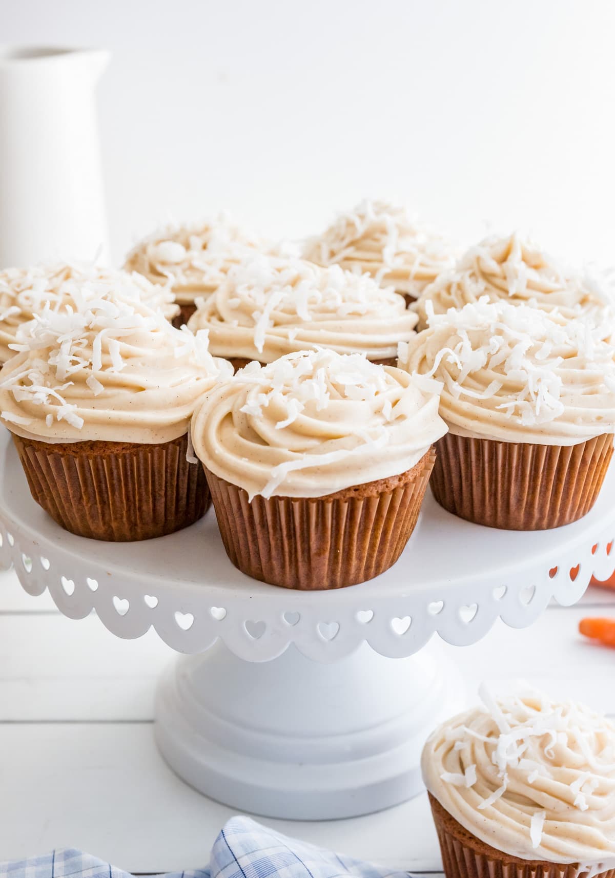 Carrot Cake Cupcakes on a white cake stand.