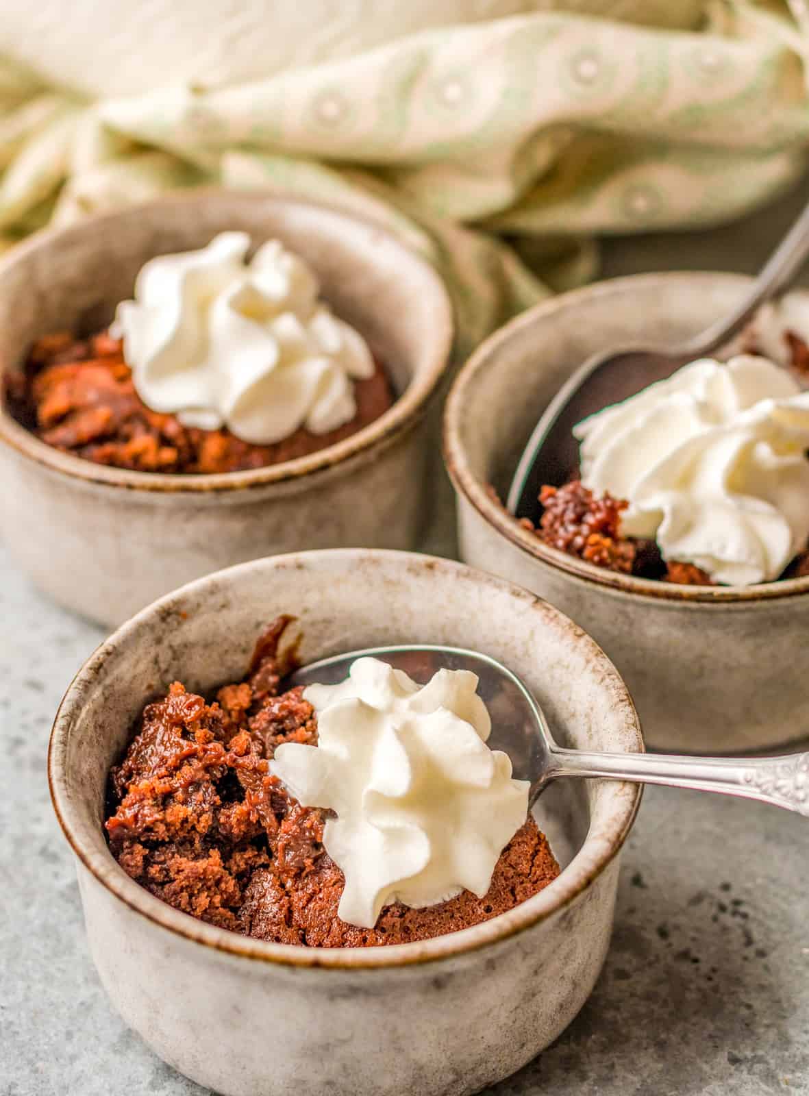 Chocolate Pudding Cake in individual bowls with whipped topping