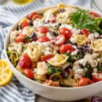 Square photo of finished pasta salad in white serving dish