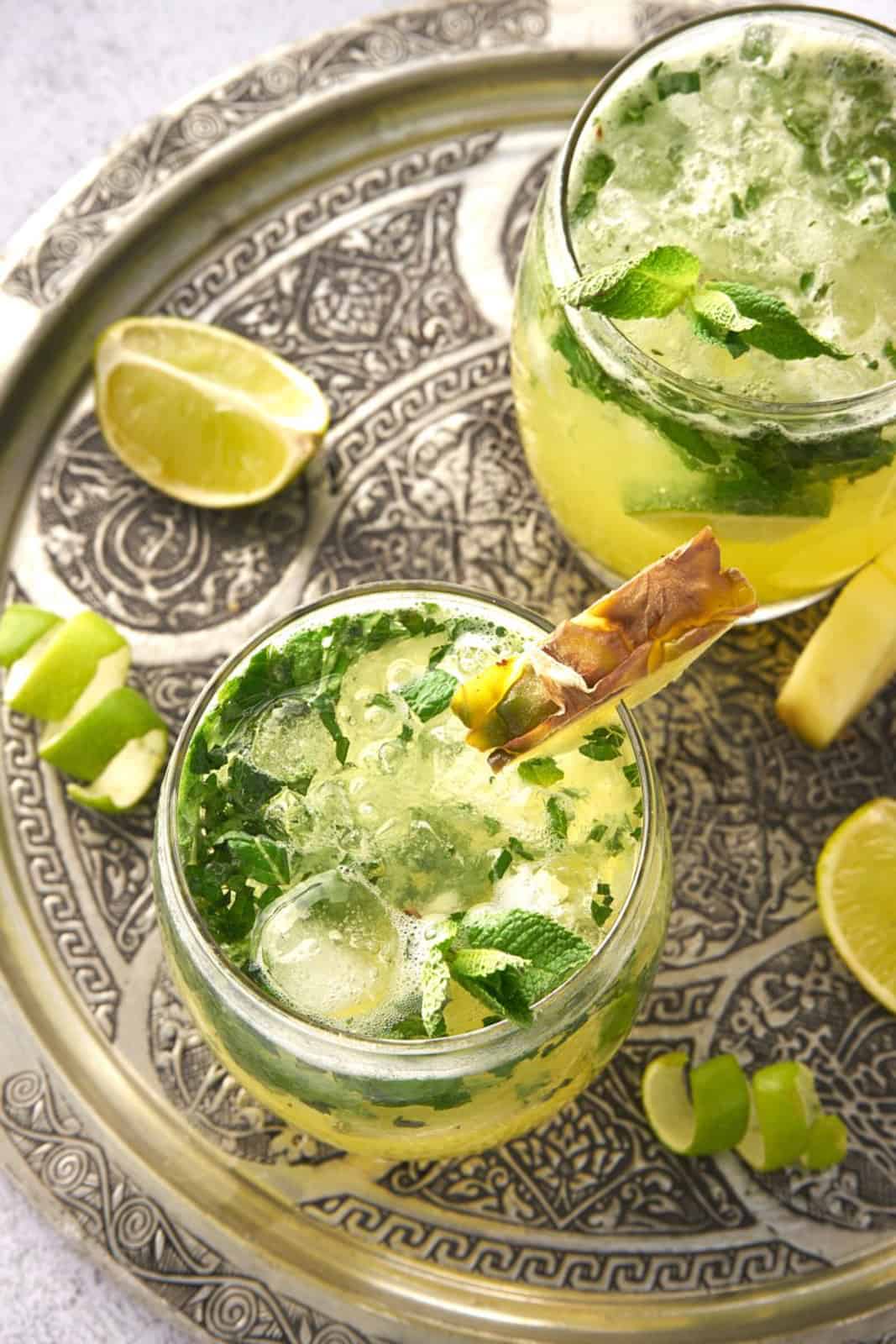 Overhead of two Pineapple Mojitos on silver platter