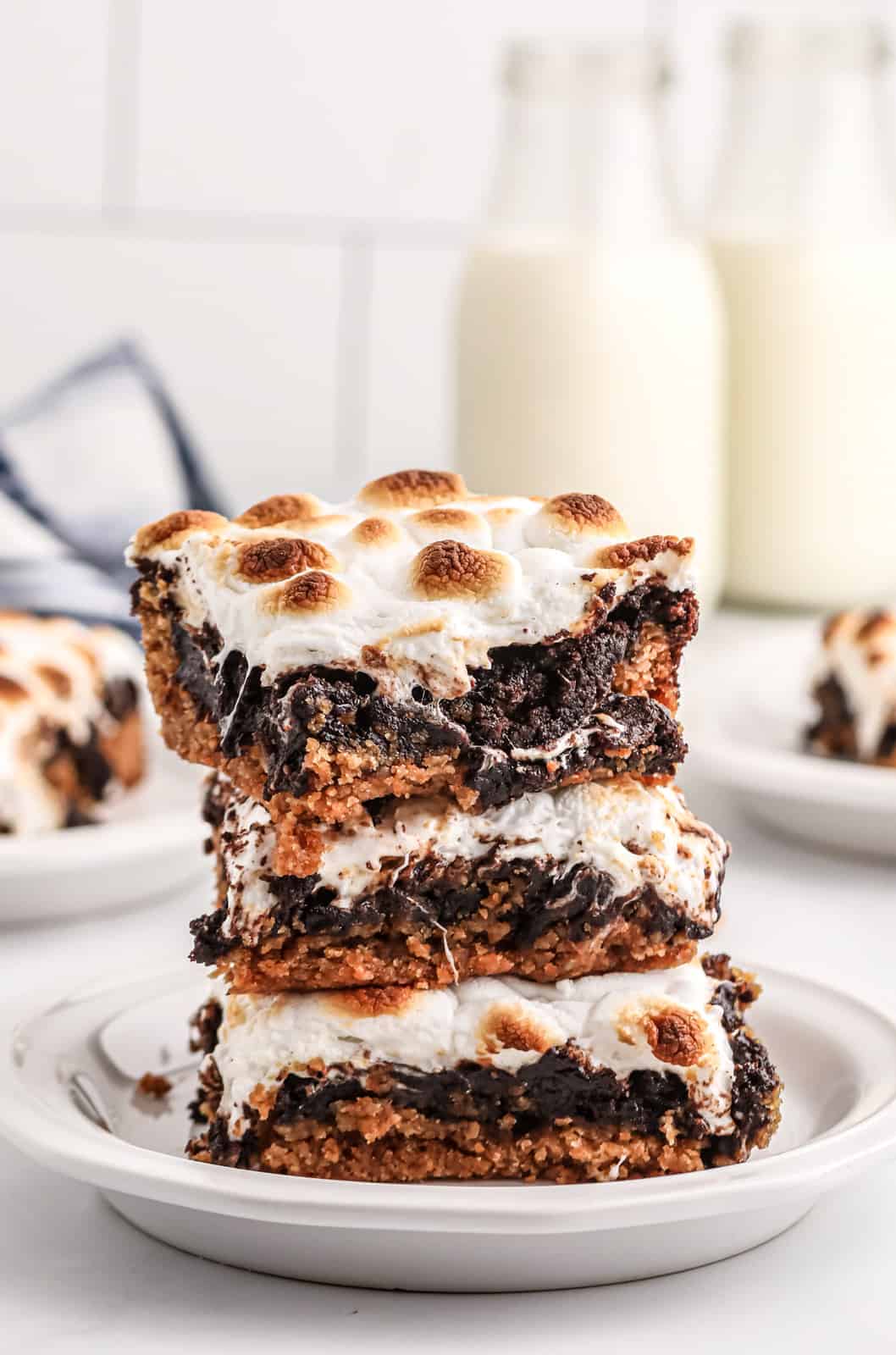 Three stacked S'mores Bars on white plate showing layer