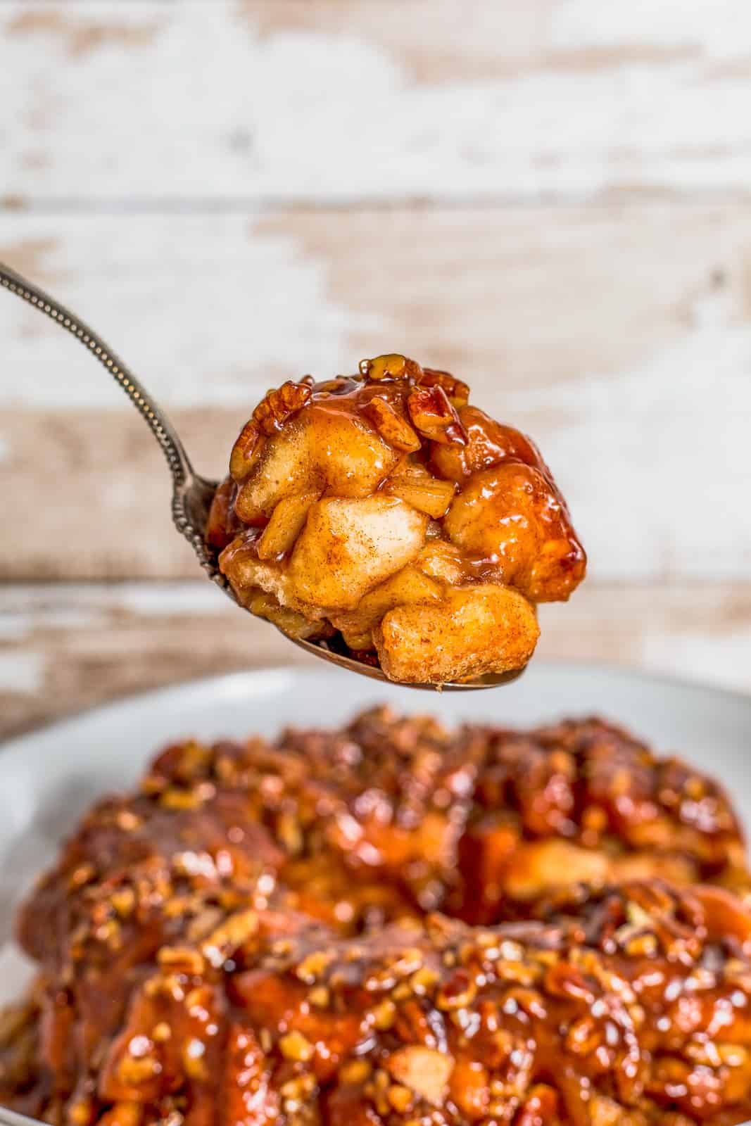 Spoon holding up some of the Apple Monkey Bread