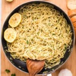 Square image of spaghetti finished in pan with lemons.